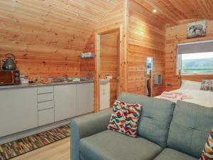 a living room with a couch in a log cabin at Willow in Ulverston