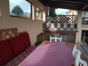 a living room with a red couch and a table at Vila Panorama in Izgrev
