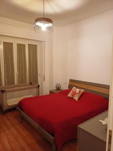 a bedroom with a bed with a red blanket at Casa Sirio -Rapallo in Rapallo