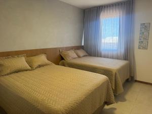 Ένα ή περισσότερα κρεβάτια σε δωμάτιο στο Village Itacimirim