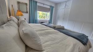 a large white bed with pillows in a bedroom at The Ark Holiday Home in Stanford