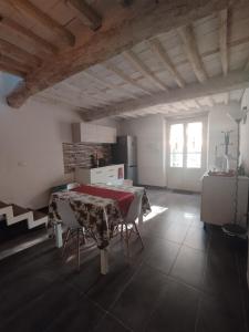 a kitchen with a table and chairs in a room at Denisoph Apartment in Lucca