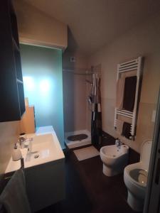 a bathroom with a sink and a toilet at Denisoph Apartment in Lucca