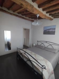 a bedroom with a bed in a white room at Denisoph Apartment in Lucca