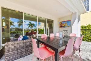 a dining room with a table and pink chairs at LC517T The Chic Abode at Liberty Bluff in Kissimmee