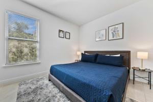 a bedroom with a blue bed and a window at LC517T The Chic Abode at Liberty Bluff in Kissimmee +34 photos
