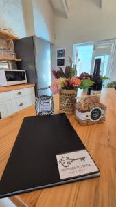 a kitchen with a counter with a laptop on a table at Bramber cottage Stay a while in Stanford +22 photos