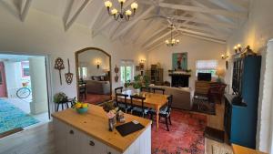 a living room with a table and a dining room at Bramber cottage Stay a while in Stanford