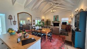 a living room with a table and a dining room at Bramber cottage Stay a while in Stanford