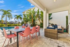 a patio with a table and chairs and a pool at LC517T The Chic Abode at Liberty Bluff in Kissimmee