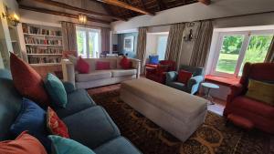 a living room with a blue couch and chairs at Coppull Private Nature Reserve in Stanford