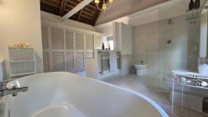a white bathroom with a tub and a toilet at Coppull Private Nature Reserve in Stanford