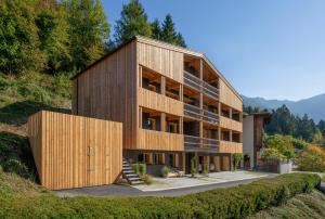 a building with wooden panels on the side of a hill at bläkat in Ramsau im Zillertal
