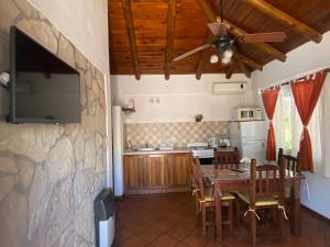 a kitchen and dining room with a table and a flat screen tv at TOLHUIN COLON in Colón