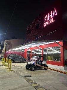 a golf cart parked in front of a building at AHAhotel in Bigaa