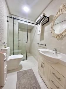 a bathroom with a sink and a toilet and a mirror at Modern Comfort Studio, la corniche in Mohammedia