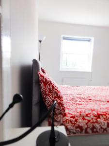 a bedroom with a red bed with a red blanket at Camden Habitat in London
