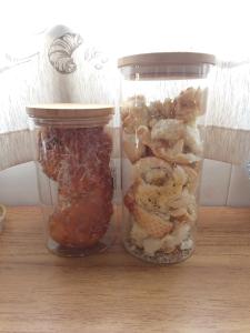 two glass jars filled with different types of food at Pousada São Jorge in Araxá