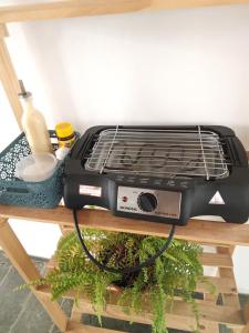 a black toaster oven sitting on a table at Pousada São Jorge in Araxá