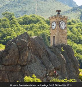 a clock tower sitting on top of a rock at Charmant studio en Ardèche - village médiéval in Burzet