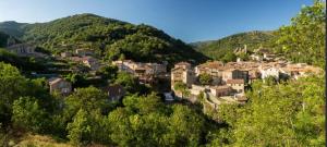 a small town in the mountains with houses at Charmant studio en Ardèche - village médiéval in Burzet