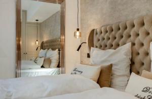 een slaapkamer met twee bedden en een grote spiegel bij Kampen Royal in Kampen +19 foto's