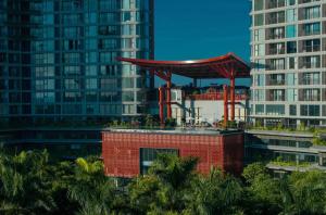 a red structure on top of a building with tall buildings at Sakura Room Ở Space Ecopark in Kim Quan