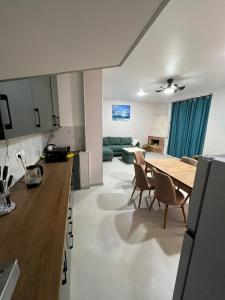 a kitchen and living room with a table and chairs at Villa Marhaba in Borjomi