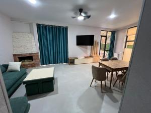 a living room with a green couch and a table at Villa Marhaba in Borjomi