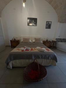 a bedroom with a bed with a basket on the floor at Nene' in Fasano