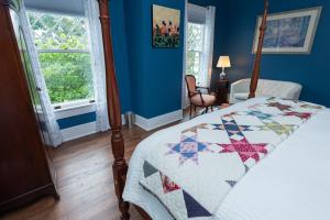 a bedroom with a bed with a quilt on it at Old Furnace Inn in Harrisonburg