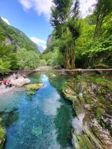a river in the middle of a valley at Kulla e Gjyshit - Guest House in Theth