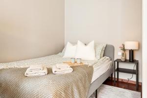 a bedroom with a bed with two towels on it at Modern Suites, Excellent Location in the heart of Bergen in Bergen