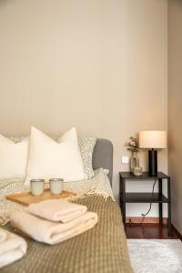 a bedroom with a bed with two bowls on a table at Modern Suites, Excellent Location in the heart of Bergen in Bergen