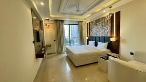 a hotel room with a bed and a large window at Hotel Maple Tree , Gomtinagar Extension , Lucknow in Lucknow