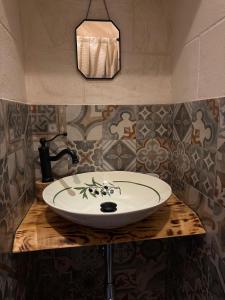 a bathroom with a white sink on a wooden counter at Nene' in Fasano
