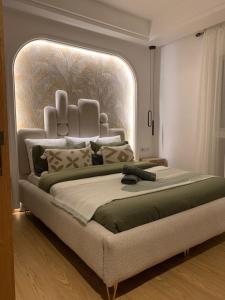 a large bed with a large headboard in a bedroom at L'élégance Taghazout in Taghazout