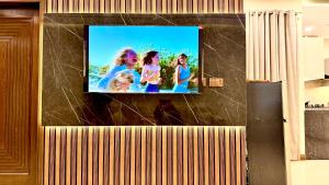 a flat screen tv on top of a wall at Executive 2BHK in Zeta Mall in Islamabad