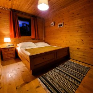 a bedroom with a bed in a wooden room at Alpine Auszeit am Wilden Kaiser in Scheffau am Wilden Kaiser