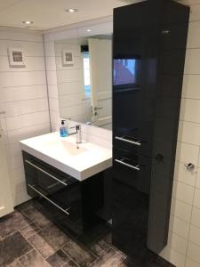 a bathroom with a sink and a mirror at Cozy top apartment in Egersund city with 3 bedrooms in Egersund