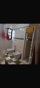 a bathroom with two sinks and a toilet and a shower at House Silvia & Nuno´s in Machico +15 photos