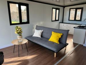 a living room with a blue couch and yellow pillows at Finca La Suerte in Chimiche
