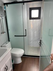 a bathroom with a toilet and a glass shower at Finca La Suerte in Chimiche +18 photos