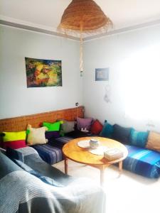 a living room with a couch and a table at Villa Rabia in Sidi Kaouki