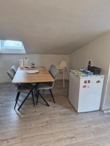 a dining room with a table and a refrigerator at Apartment close to the sea in the most central of city in Antalya