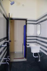 un baño con lavabo y ducha en AB Island Homestay, en Munroe Island