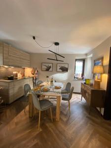a kitchen and dining room with a table and chairs at Les Arnauds in Bardonecchia