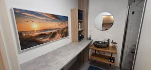 a bathroom with a sink and a mirror at COSY KRANENVEN - 4 guests in Lommel