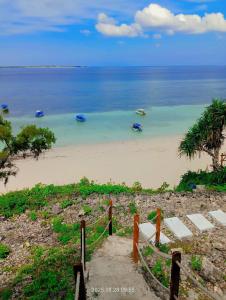 a view of a beach with boats in the water at Casablanca Bira Resort in Tabutule