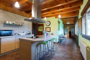 a kitchen with a large island with bar stools at Complejo Rural La Venta Vieja by CABANA Rentals in Ortigosa del Monte